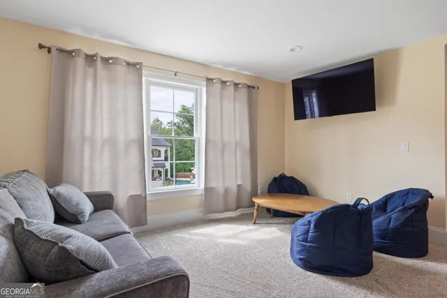 a front view of a house with swimming pool having outdoor seating