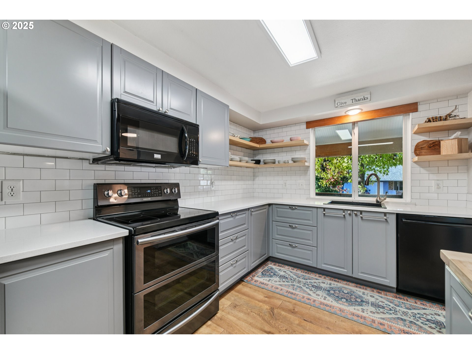 17226 Southwest Baker Street Beaverton, OR 97007 - Photo 14 of 34 a kitchen with a sink stove and microwave