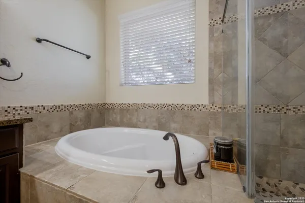 a bathroom with a tub and a shower