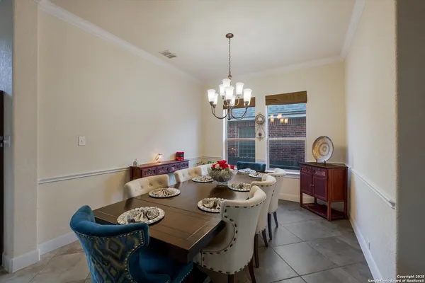 a view of a dining room with furniture and chandelier
