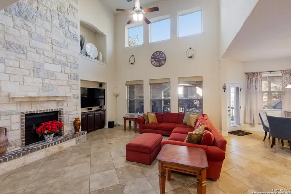 a living room with furniture a fireplace and a flat screen tv