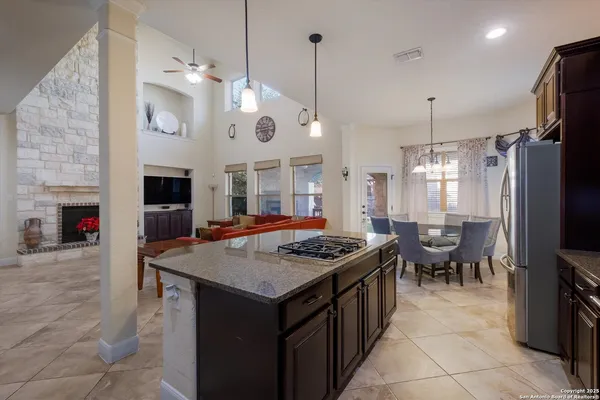 a kitchen with stainless steel appliances granite countertop a stove a sink and a refrigerator