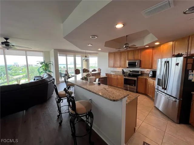 a kitchen with granite countertop lots of counter top space and stainless steel appliances