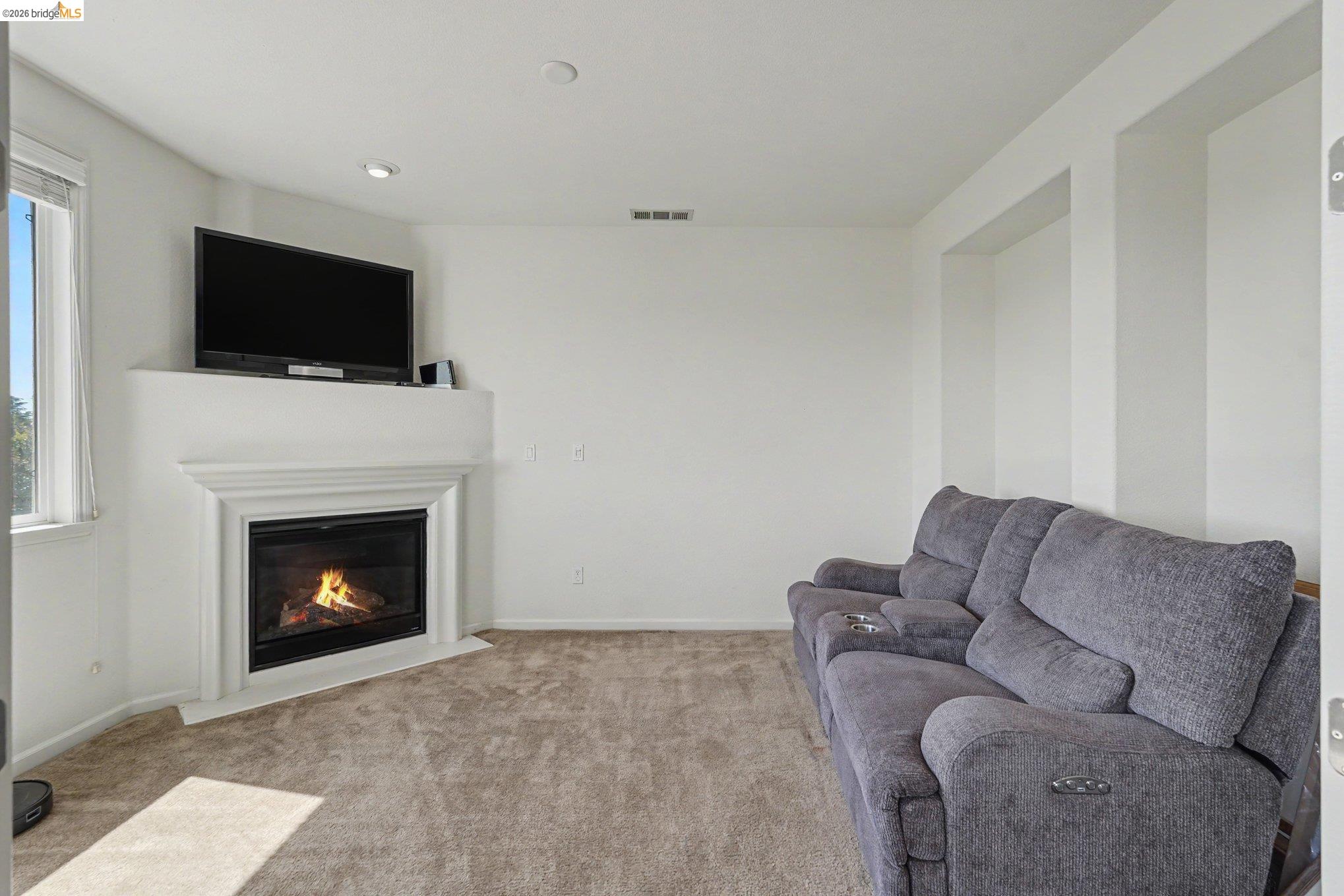 106 Little Ranch Circle Oakley, CA 94561 - Photo 23 of 34 Living space featuring a corner fireplace with a white mantel, recessed lighting, and a large window