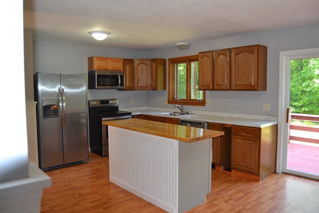 61 Monson Road Wales, MA 01081 - Photo 30 of 41 a kitchen with stainless steel appliances granite countertop a sink a stove and a refrigerator