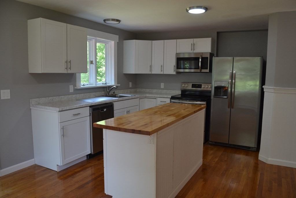 61 Monson Road Wales, MA 01081 - Photo 7 of 41 a kitchen with a sink stove and refrigerator