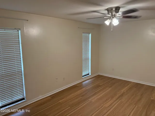 wooden floor in an empty room with a window