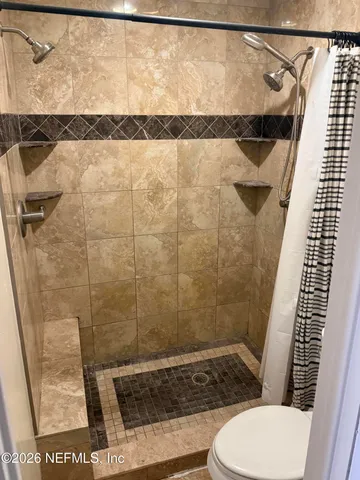 a bathroom with a shower and toilet