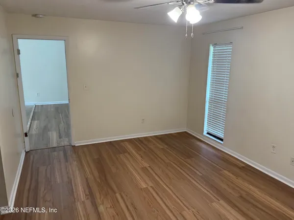 wooden floor in an empty room with a window