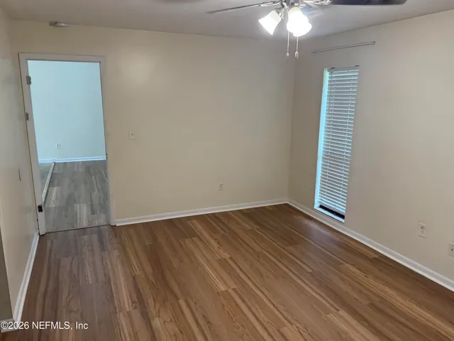 wooden floor in an empty room with a window