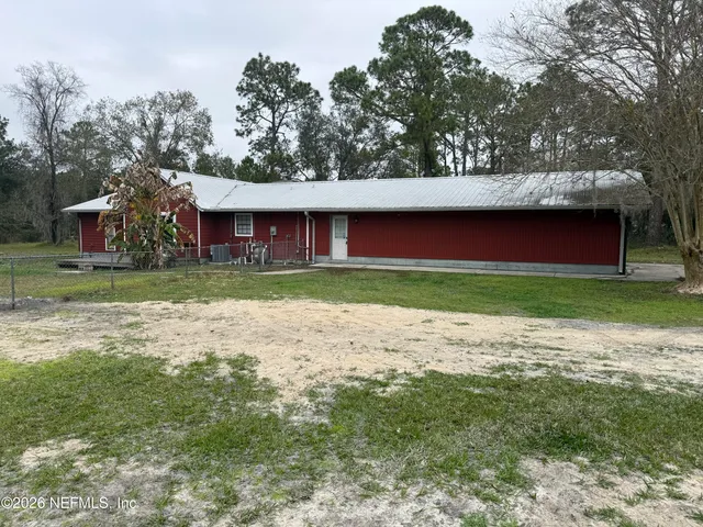 a view of a house with a garden and pathway