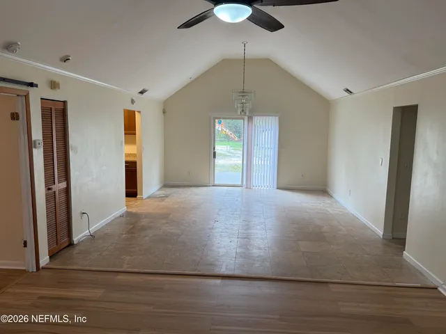 wooden floor in an empty room with a window