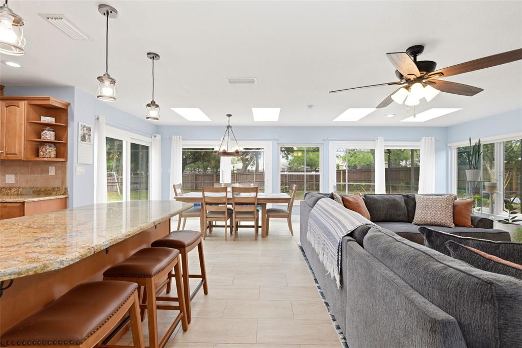 7432 Sparkling Lake Road Orlando, FL 32819 - Photo 9 of 54 a living room with furniture ceiling fan and a large window