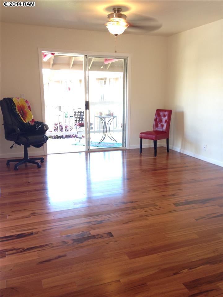 480 Kenolio Road, Unit 13204 Kihei, HI 96753 - Photo 11 of 18 a living room with furniture and a window