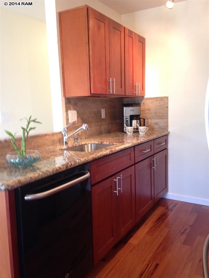 480 Kenolio Road, Unit 13204 Kihei, HI 96753 - Photo 12 of 18 a kitchen with a sink and cabinets