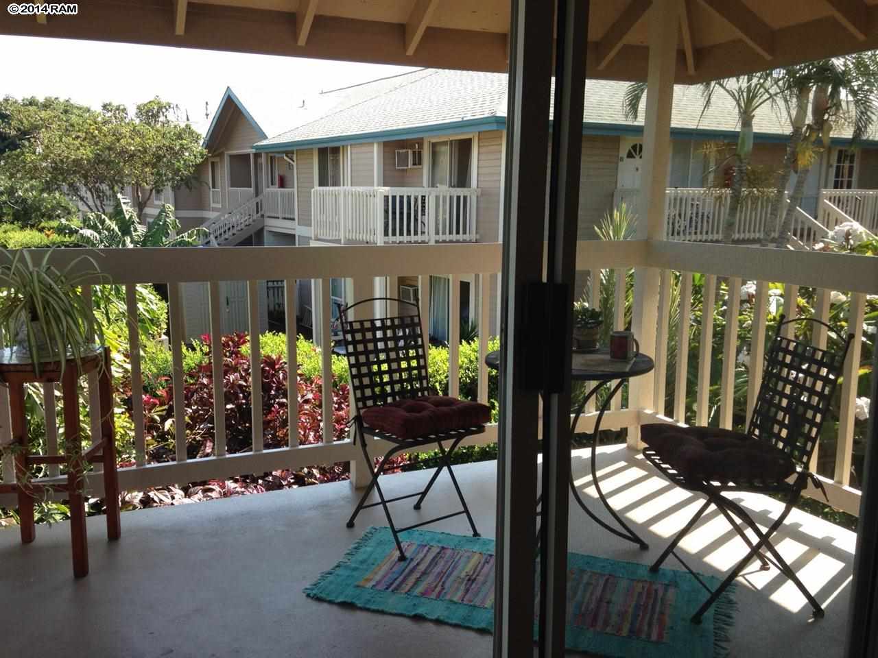 480 Kenolio Road, Unit 13204 Kihei, HI 96753 - Photo 14 of 18 a view of a chairs and table in the back yard of the house