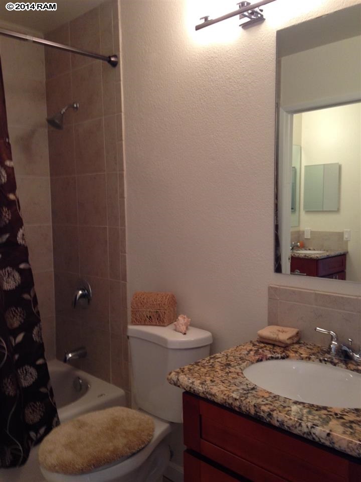 480 Kenolio Road, Unit 13204 Kihei, HI 96753 - Photo 7 of 18 a bathroom with a granite countertop sink and a mirror