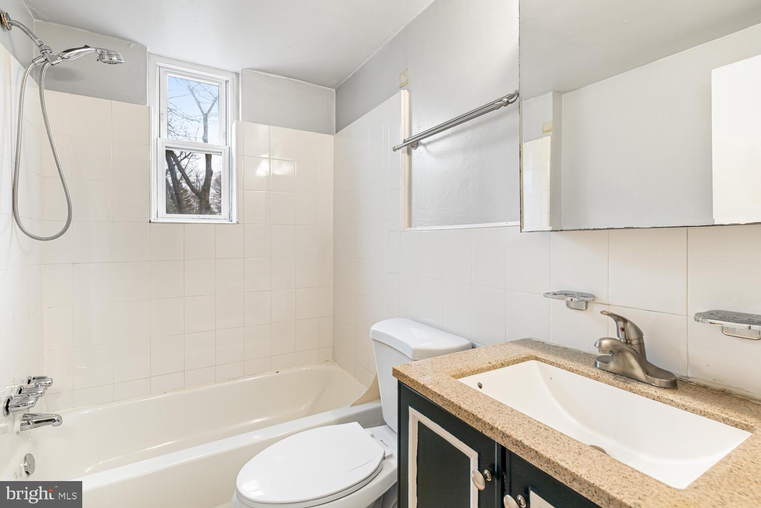 1600 Church Road, Unit D205 Wyncote, PA 19095 - Photo 13 of 21 a bathroom with a granite countertop sink a toilet and shower