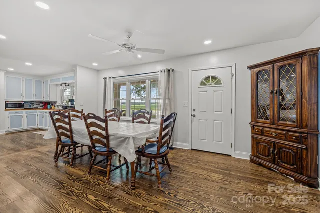 a view of a dining room with furniture window and wooden floor