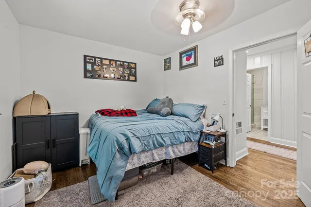 a bedroom with a bed and a chandelier
