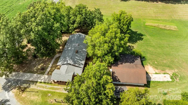 a view of a house with a yard balcony and wooden fence