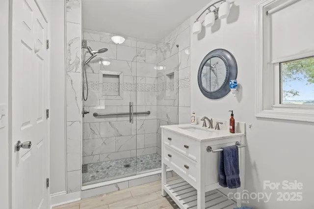 a bathroom with a sink a mirror and a shower