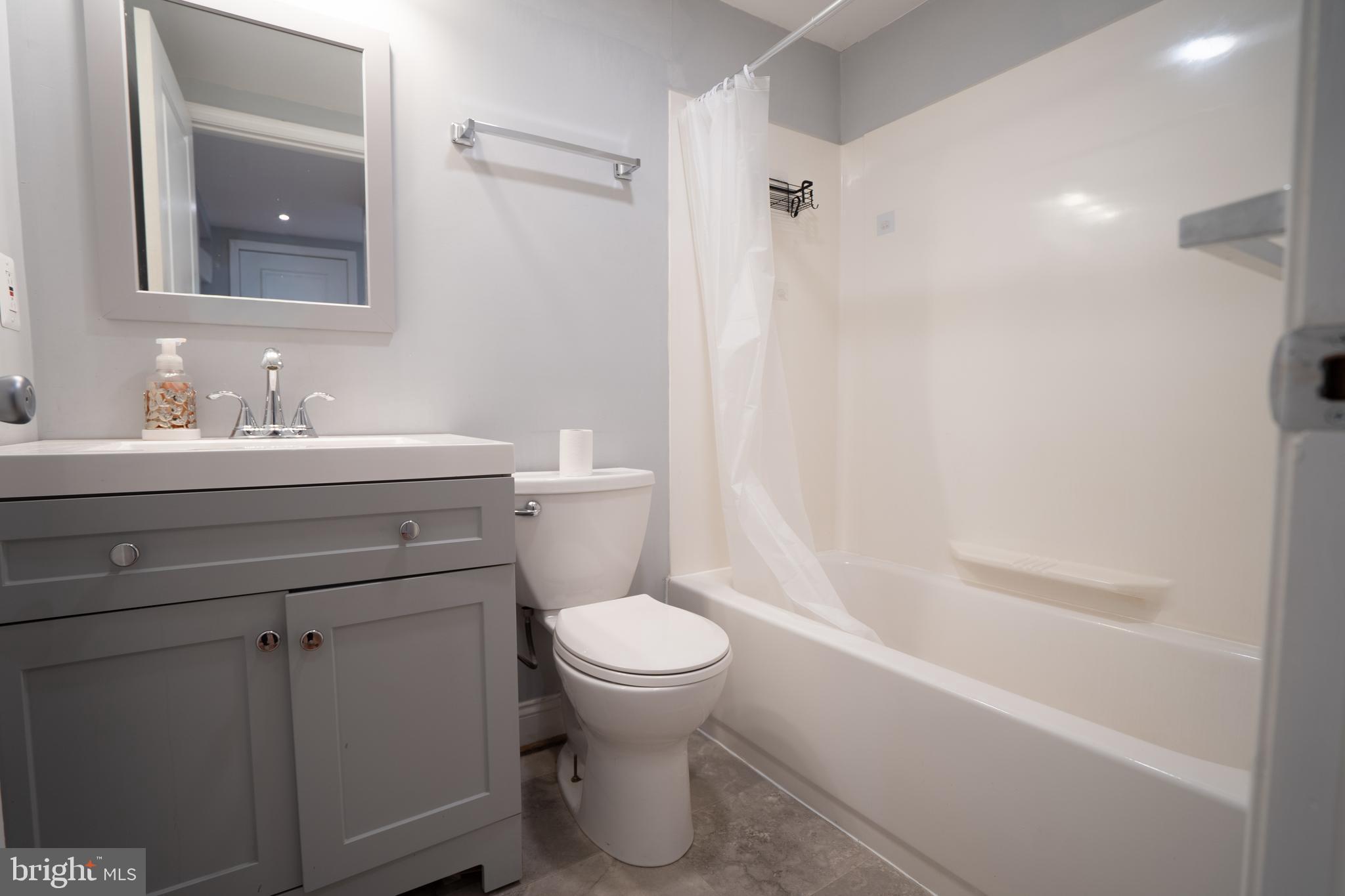 3804 Falls Road Baltimore, MD 21211 - Photo 10 of 18 a bathroom with a sink toilet vanity and shower