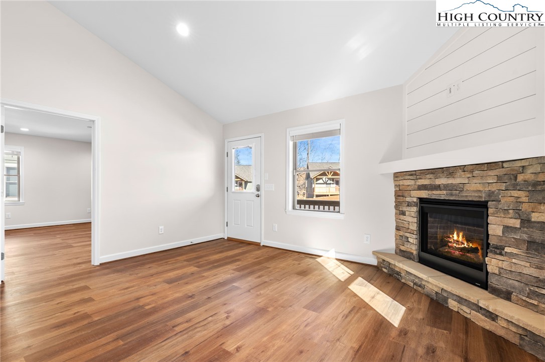 245 Ava Way, Unit 108 Boone, NC 28607 - Photo 11 of 31 a view of empty room with wooden floor and fireplace