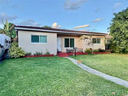 a front view of house with yard and outdoor seating