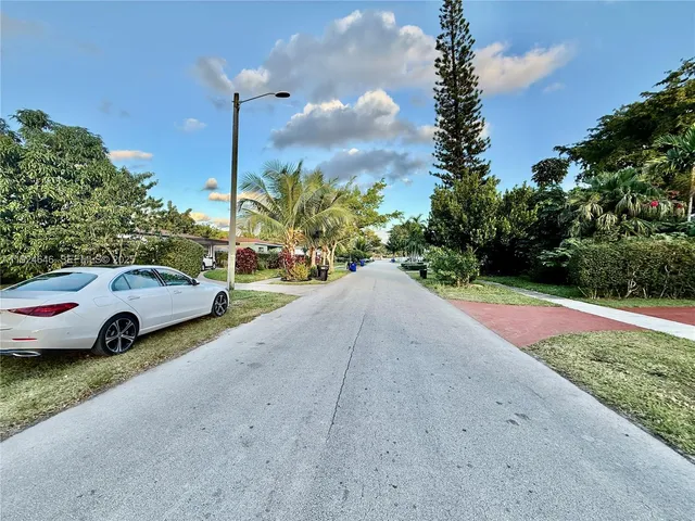 a view of street with parked cars
