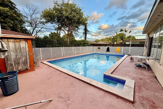 a view of roof deck with wooden floor and fence
