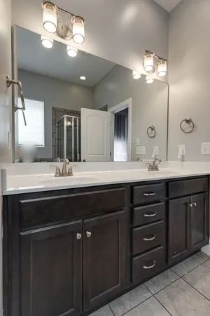 a bathroom with a double vanity sink and a mirror