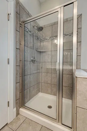 a bathroom with a glass shower door