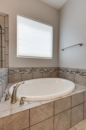 a bathroom with a bathtub and a window
