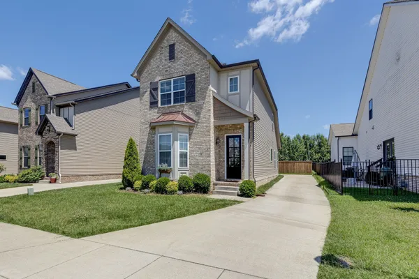 a front view of a house with a yard