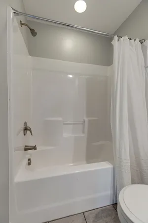 a bathroom with a bathtub and a toilet