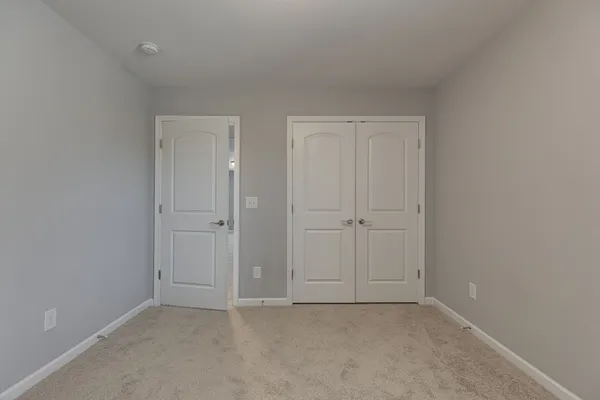 a view of an empty room and closet area