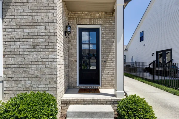 a front view of a house with a garden