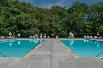 a view of swimming pool with a table and chairs