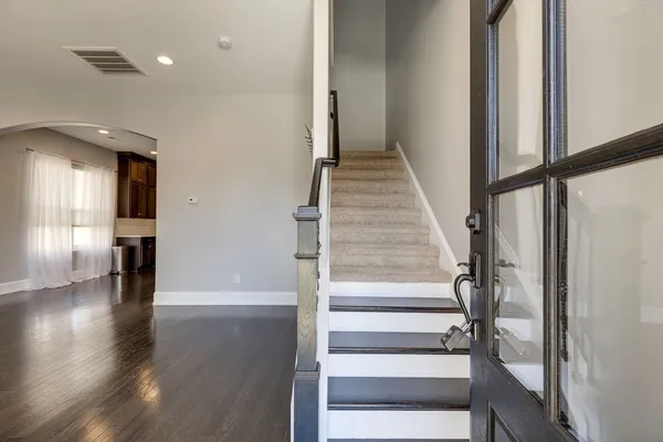 a view of entryway with wooden floor and staircase