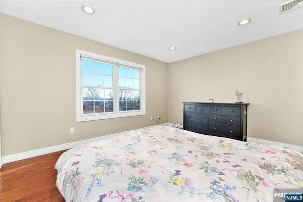 a bedroom with a bed and a dresser