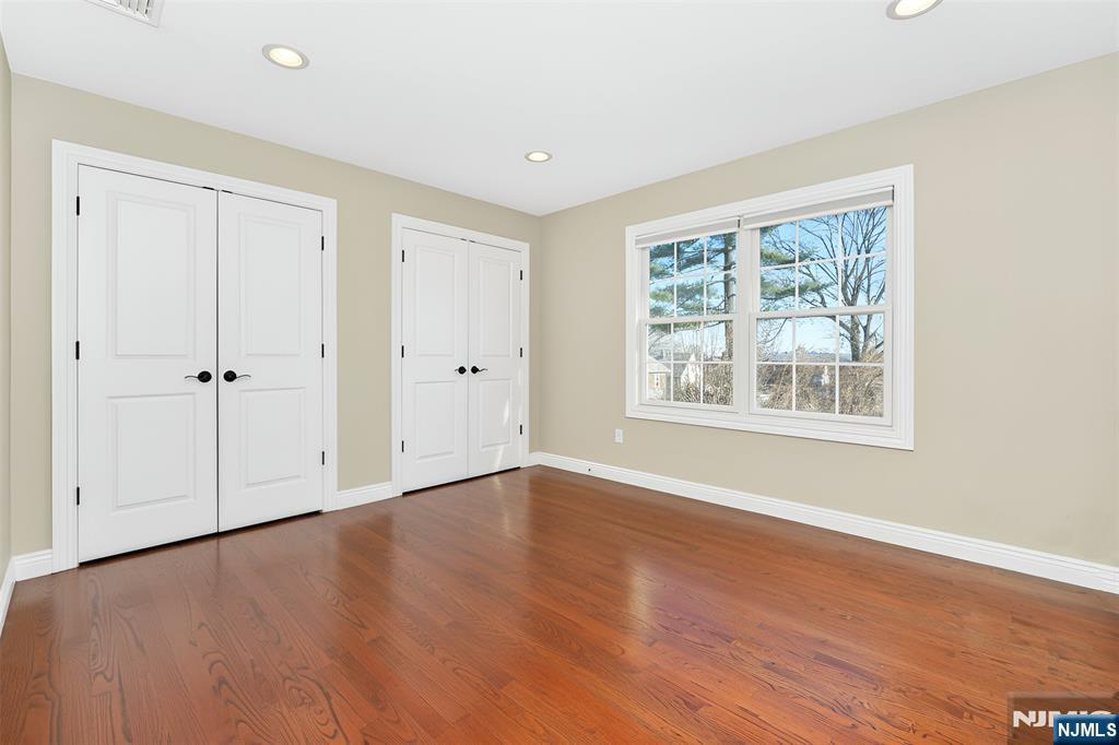 210 Hackensack Street Wood-Ridge, NJ 07075 - Photo 12 of 15 a view of an empty room with wooden floor and a window