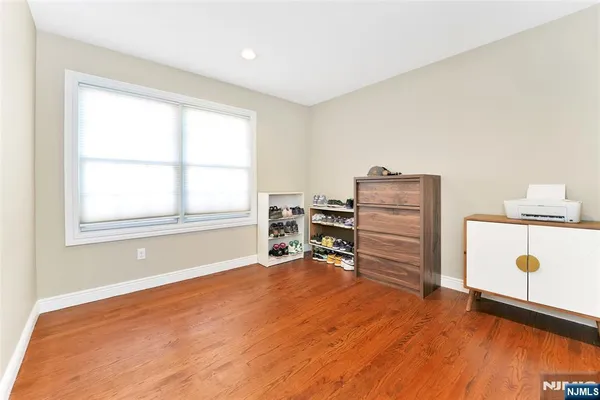 a view of room with window and a ceiling fan