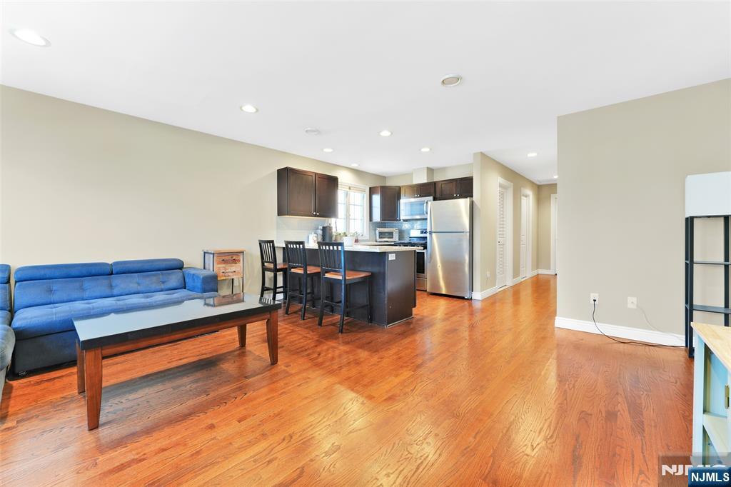 210 Hackensack Street Wood-Ridge, NJ 07075 - Photo 2 of 15 a living room with furniture and a wooden floor