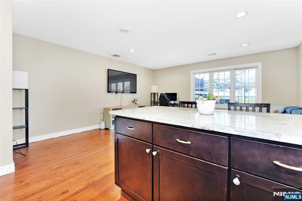 210 Hackensack Street Wood-Ridge, NJ 07075 - Photo 4 of 15 a kitchen with stainless steel appliances granite countertop a sink window and cabinets