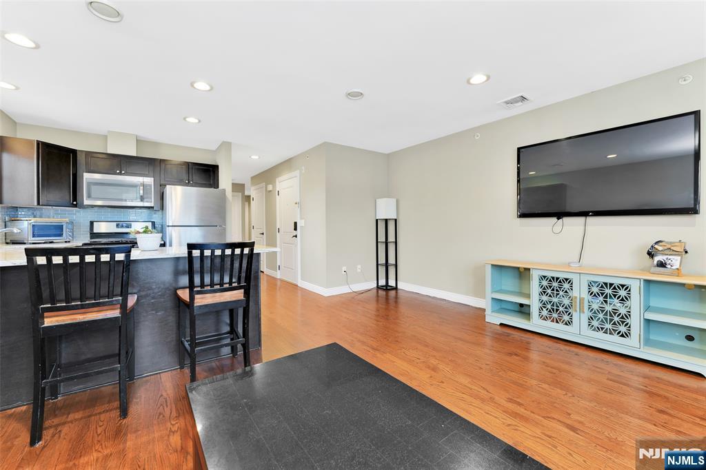210 Hackensack Street Wood-Ridge, NJ 07075 - Photo 7 of 15 a living room with furniture and a flat screen tv