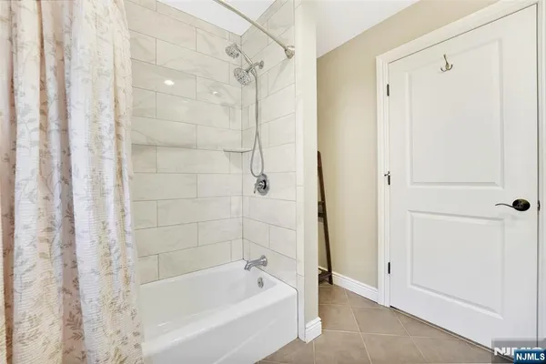 a bathroom with a bathtub and a shower
