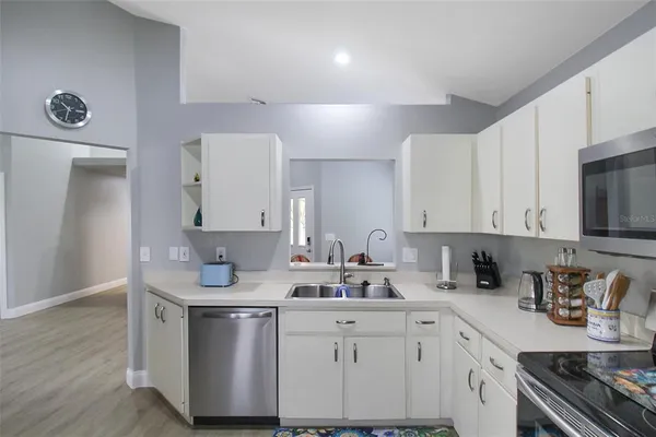 a kitchen with stainless steel appliances granite countertop a sink stove and cabinets
