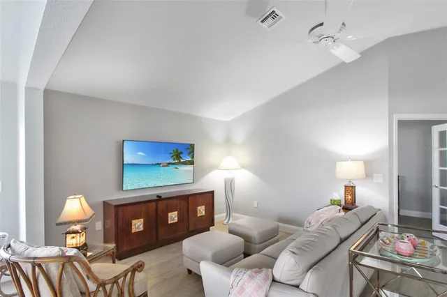 a living room with furniture a rug and a flat screen tv