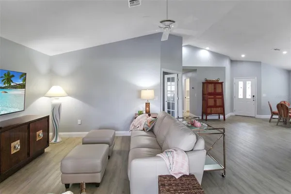 a living room with furniture a wooden floor and a fireplace
